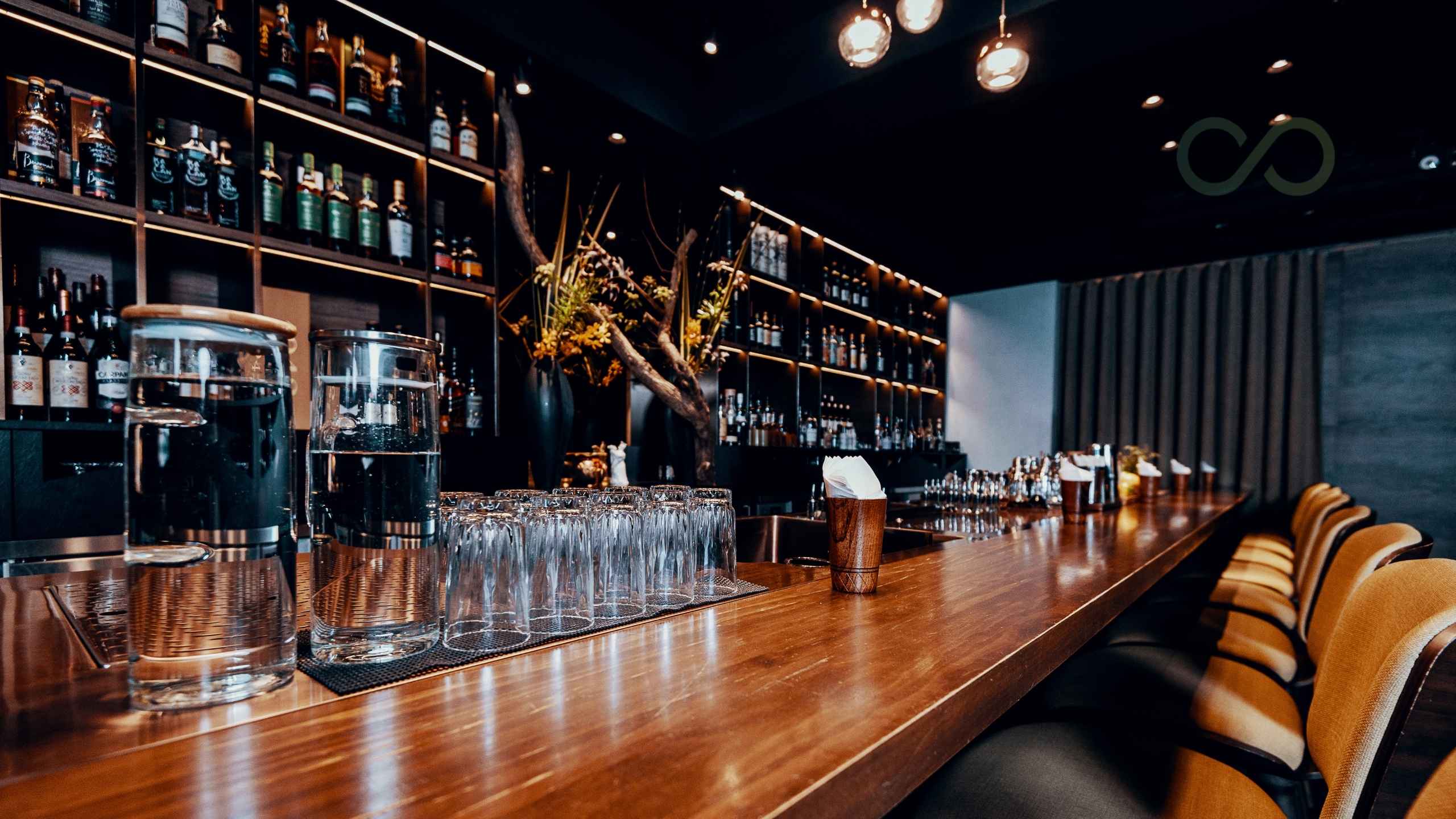 Modern sustainable bar interior with wooden counter, glassware, and backlit liquor shelves Zero Waste Bars: A 2026 Sustainable Bar Playbook for Cocktails Green Loop