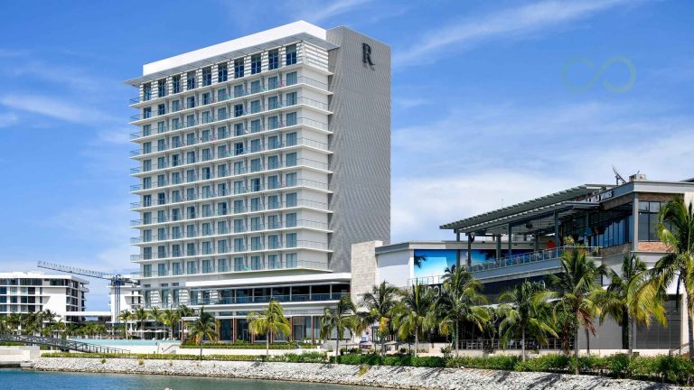 Modern waterfront hotel and commercial complex featuring contemporary architecture, palm trees, and a scenic coastal setting LEED Certification for Hotels: 2026 US and Caribbean Guide Green Loop